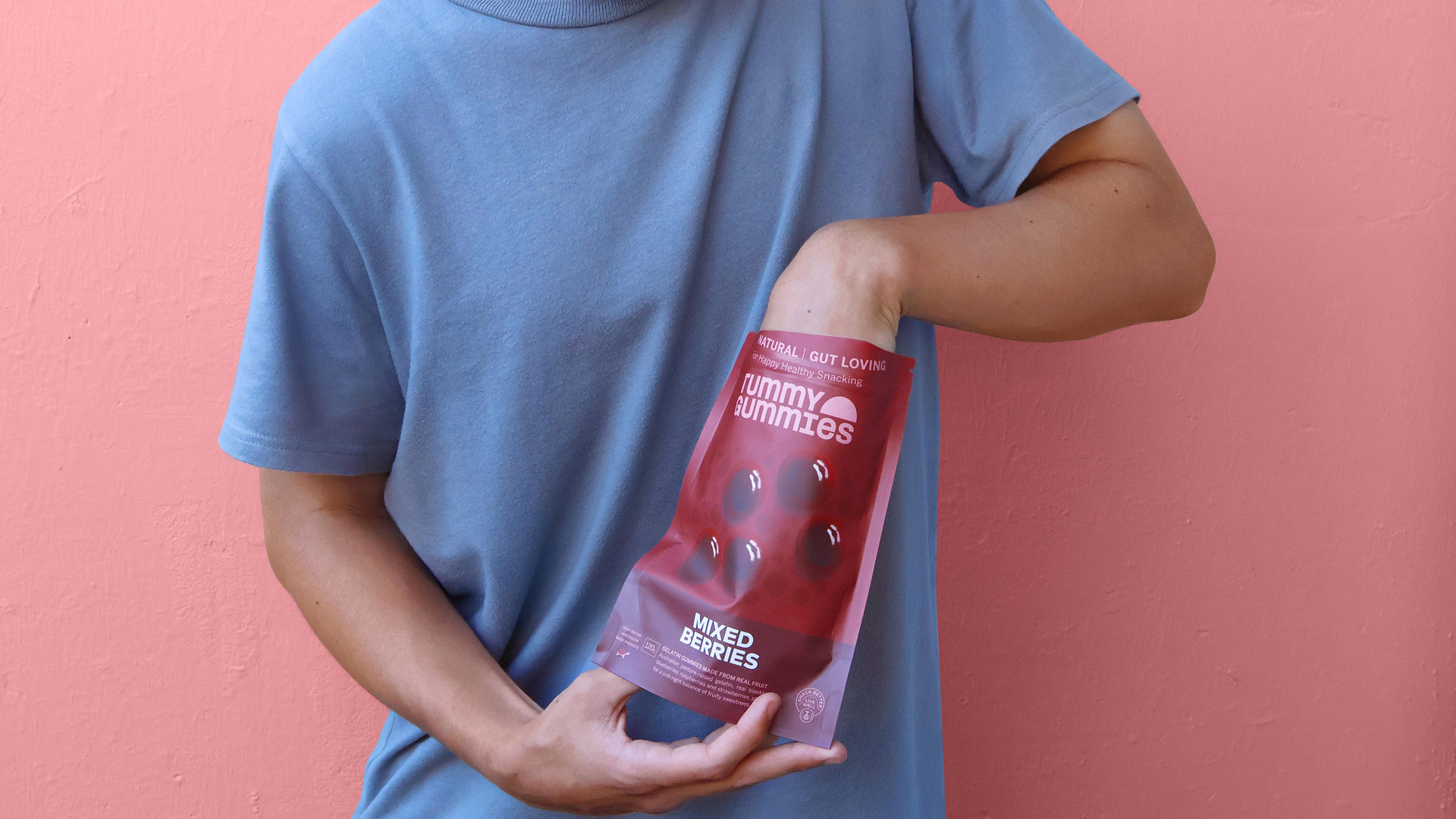 Person reaching into packaging for Tummy Gummies Mixed Berries